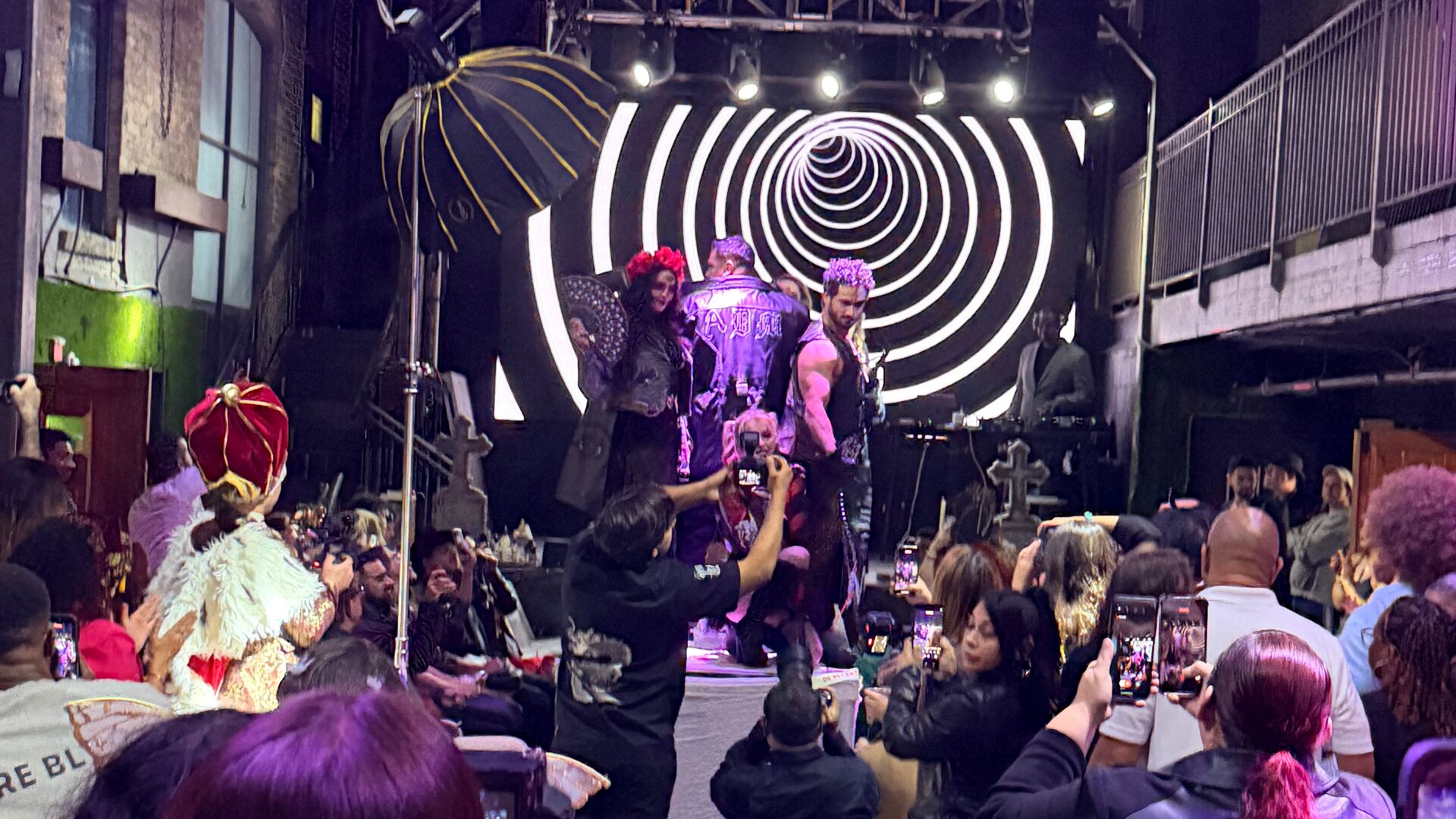 A packed room watching the runway during LuxeArt's Moda Magic Halloween fashion show